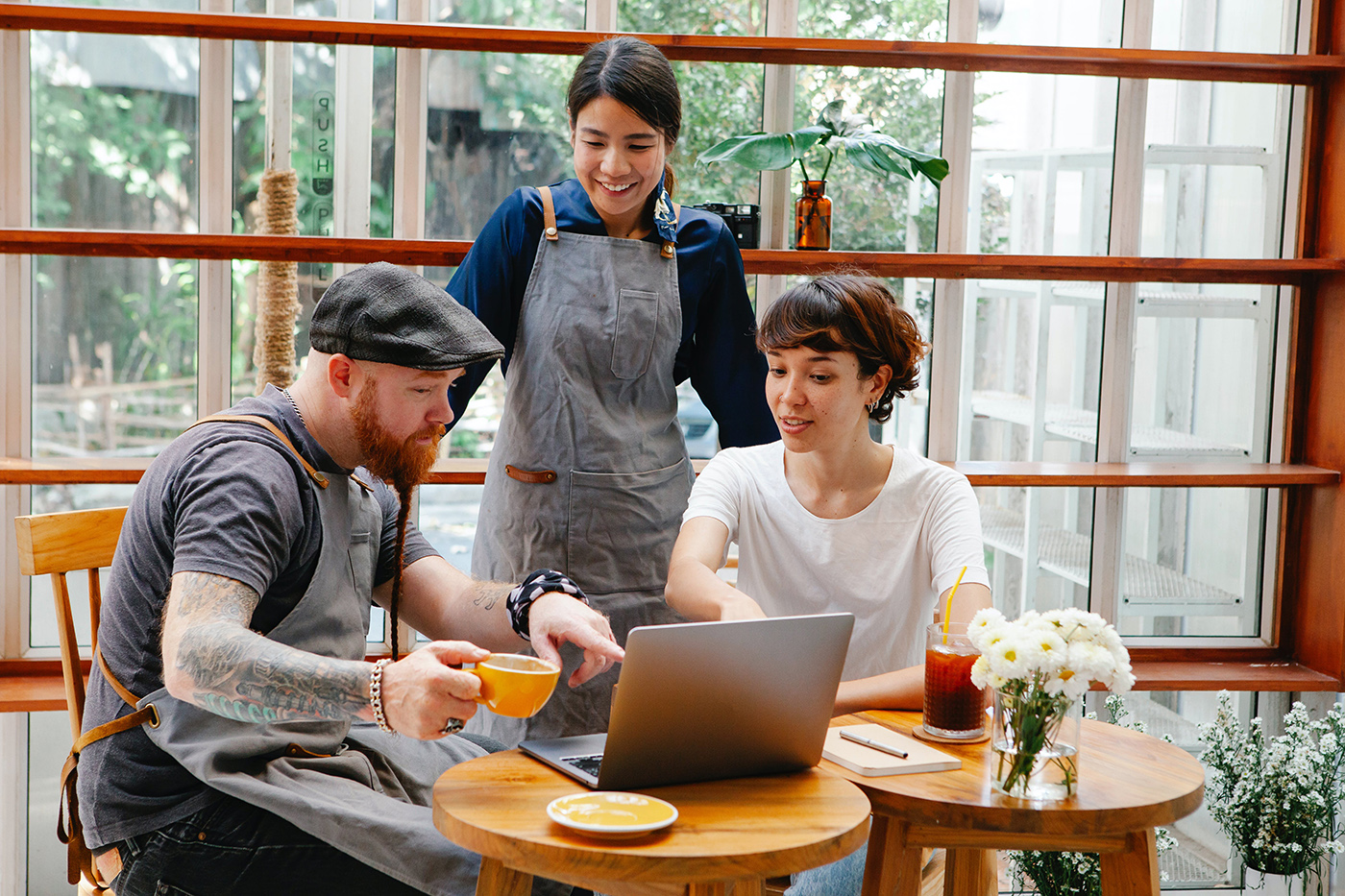 Two employees of a company sit with a consultant.